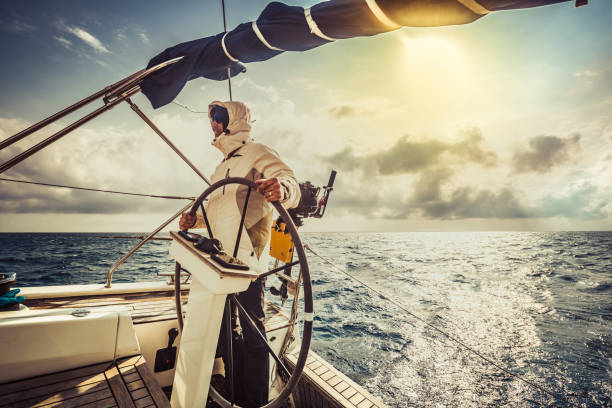 Yachting adventure man on the sailing boat.